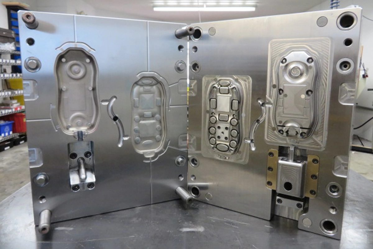 IM_101_-_Example_mold_with_visible_parting_line__ejector_pins__runner_system__cavity__core_and_side-action_core